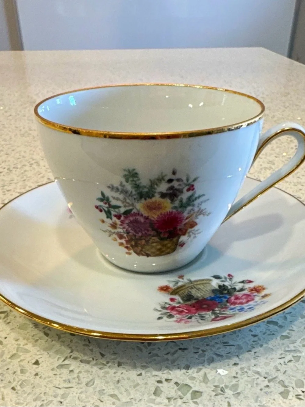 Kuba Vintage White Porcelain Teacup and Saucer with Gold Trim and Floral Basket